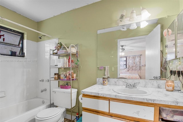 full bath featuring ensuite bathroom, ceiling fan, toilet, vanity, and  shower combination