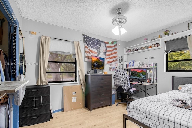 bedroom featuring a textured ceiling and wood finished floors