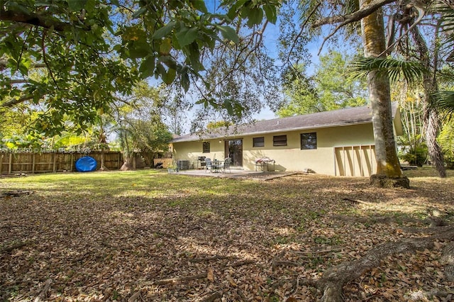 back of property featuring a patio area, fence, and stucco siding