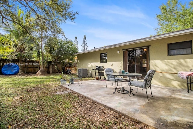 view of patio with fence, cooling unit, and area for grilling