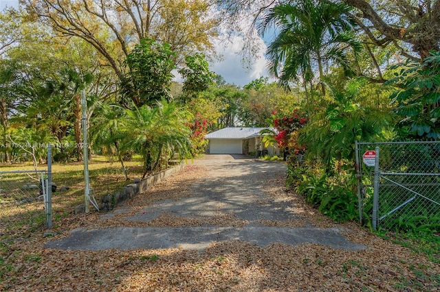 exterior space featuring a detached garage and fence