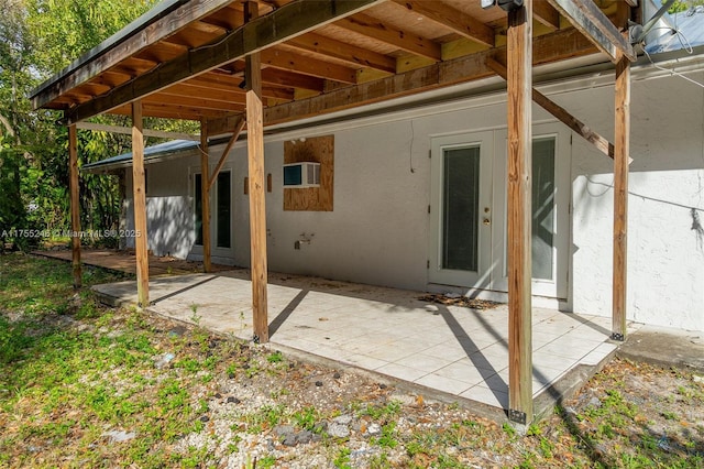 back of property featuring a patio area and stucco siding