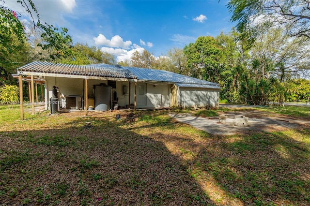 back of property with metal roof and central air condition unit