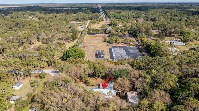 aerial view featuring a wooded view