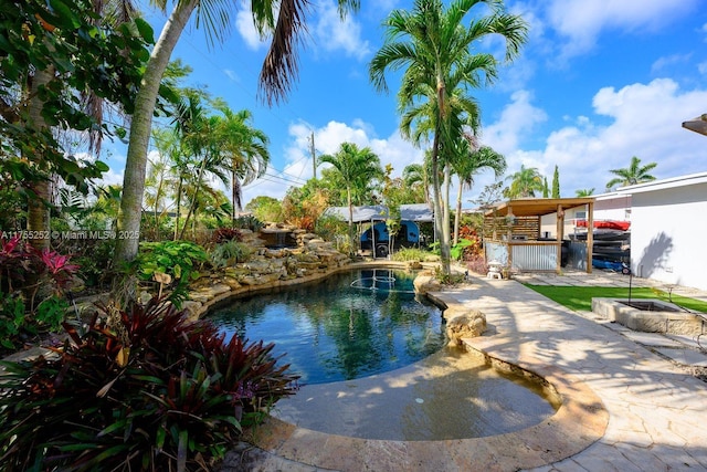 view of swimming pool featuring fence