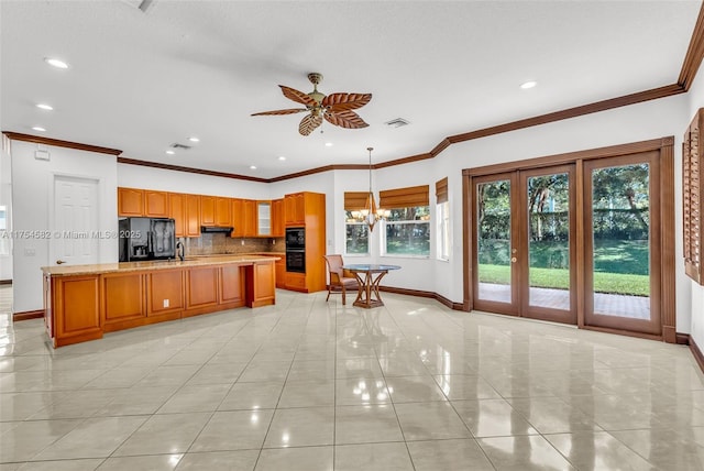 kitchen featuring tasteful backsplash, baseboards, under cabinet range hood, black appliances, and a sink