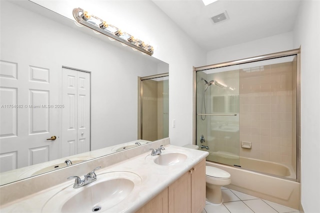 full bathroom with enclosed tub / shower combo, a sink, toilet, and tile patterned floors