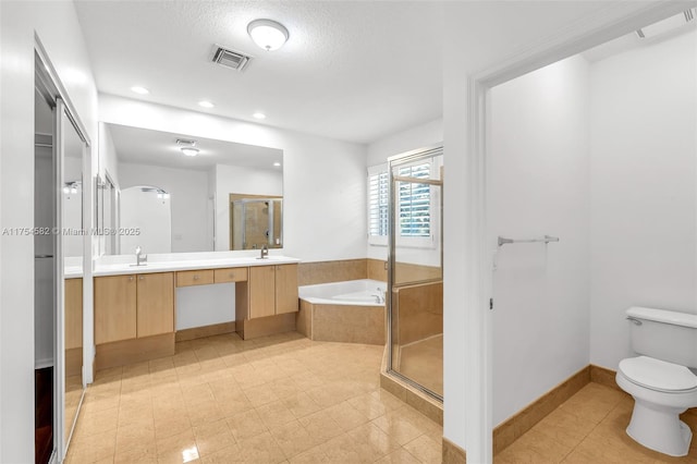 full bathroom featuring a stall shower, visible vents, toilet, a bath, and a sink