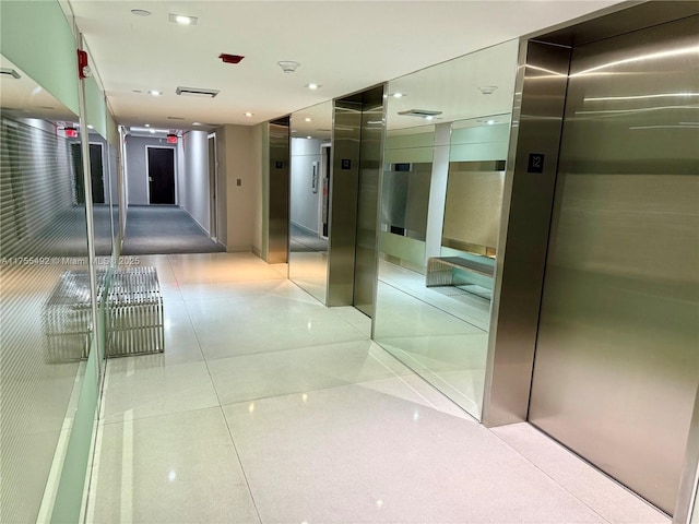 hallway featuring light tile patterned floors, elevator, and recessed lighting