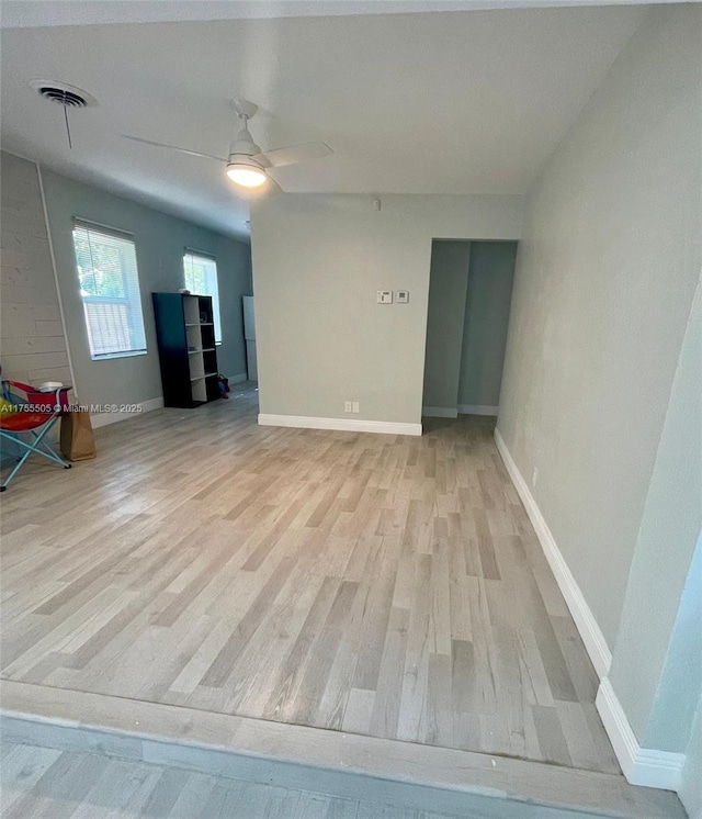 unfurnished room with visible vents, baseboards, and wood finished floors