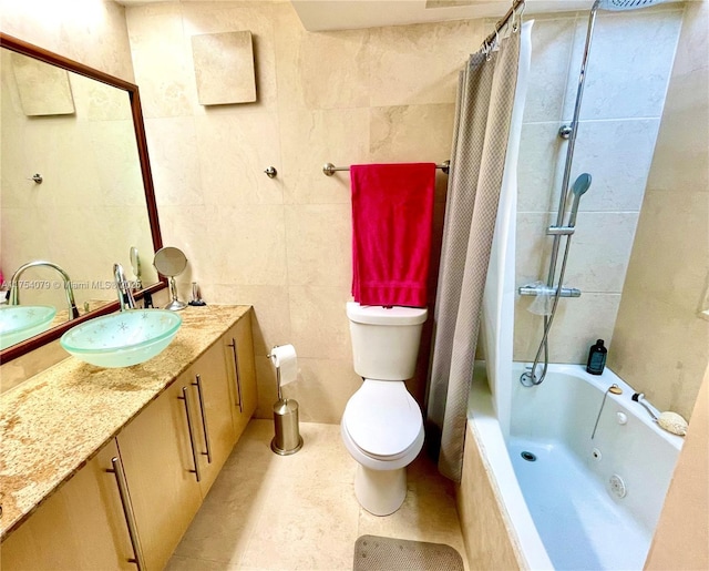 full bathroom featuring tile walls, toilet, tiled shower / bath combo, vanity, and tile patterned flooring