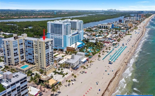 bird's eye view with a city view, a beach view, and a water view