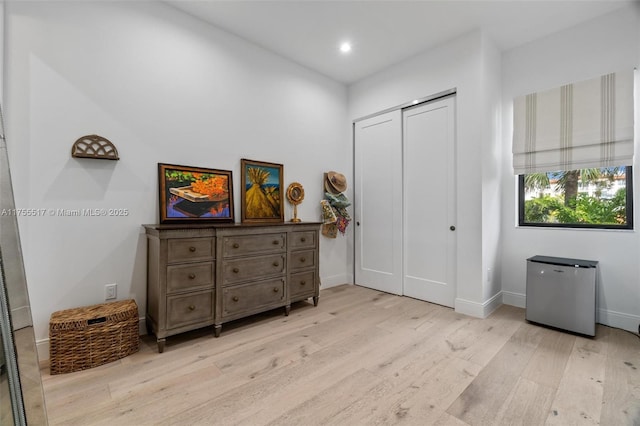 bedroom featuring recessed lighting, a closet, baseboards, and light wood-style floors