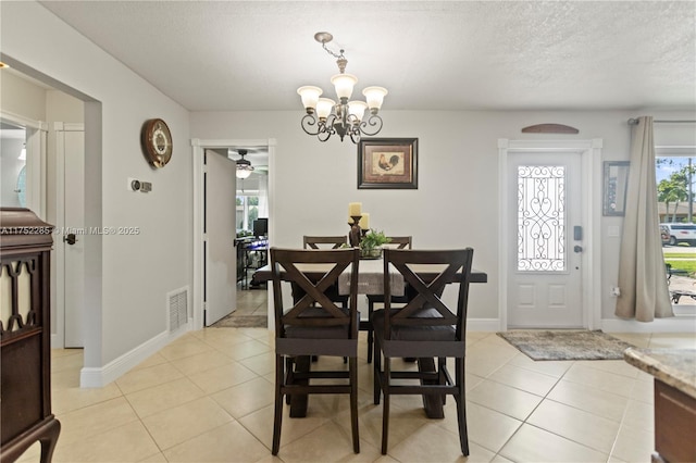 dining area with visible vents, an inviting chandelier, light tile patterned flooring, a textured ceiling, and baseboards