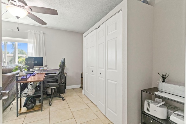 office space featuring ceiling fan, a textured ceiling, and light tile patterned floors