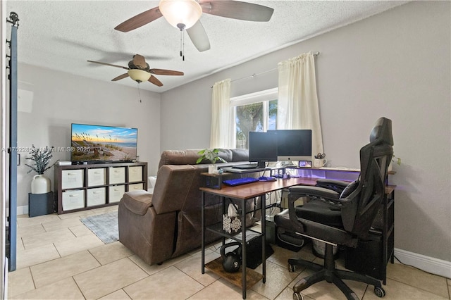 office space featuring a ceiling fan, a textured ceiling, and baseboards