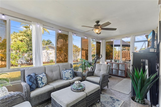 sunroom / solarium featuring ceiling fan