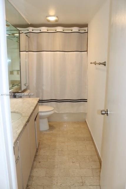 bathroom with toilet, shower / tub combo, and vanity