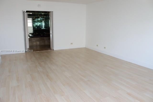 spare room with light wood-style floors