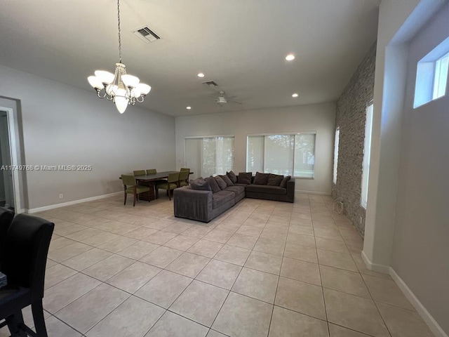 living room with visible vents, an inviting chandelier, and light tile patterned flooring