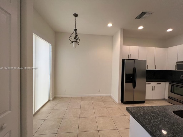 kitchen with light tile patterned floors, visible vents, hanging light fixtures, appliances with stainless steel finishes, and white cabinetry