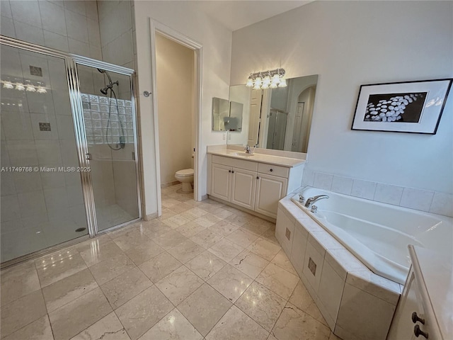 bathroom featuring toilet, a stall shower, a garden tub, and vanity