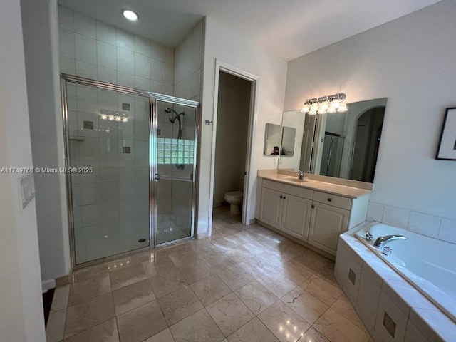 full bathroom with toilet, a garden tub, a shower stall, and vanity