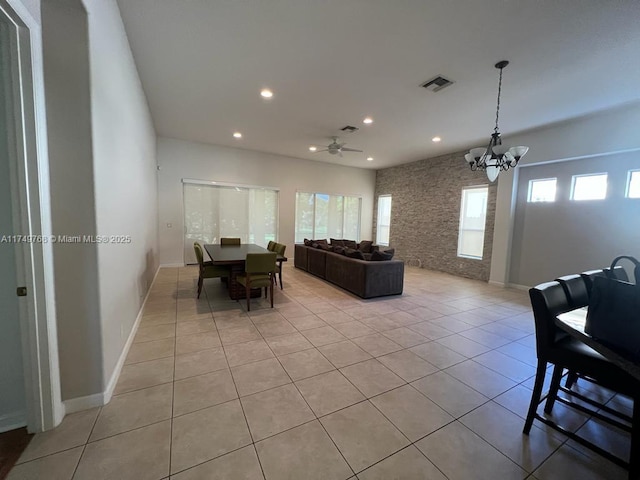 living room with recessed lighting, a healthy amount of sunlight, visible vents, and light tile patterned flooring