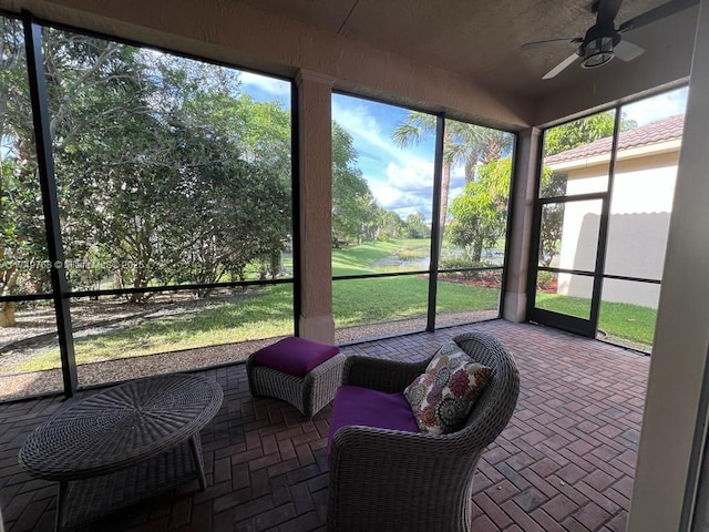 sunroom / solarium featuring ceiling fan