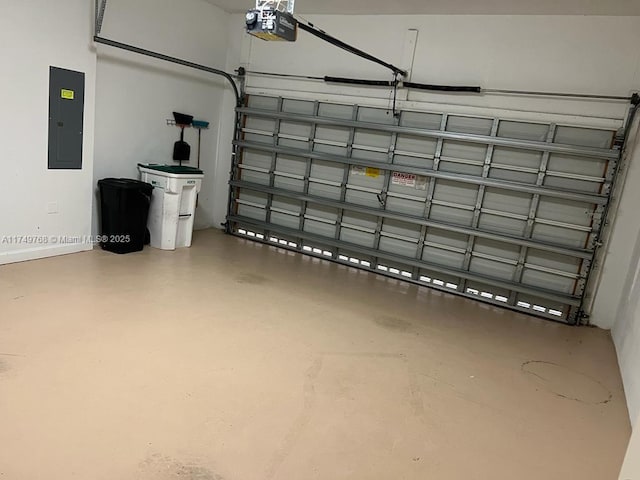 garage featuring a garage door opener, electric panel, and baseboards