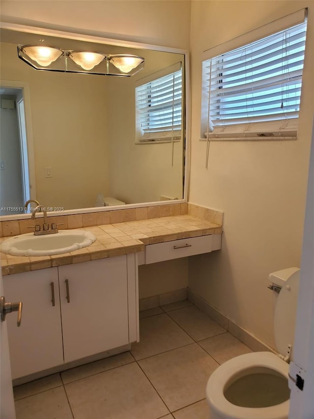 bathroom with tile patterned flooring, vanity, and toilet