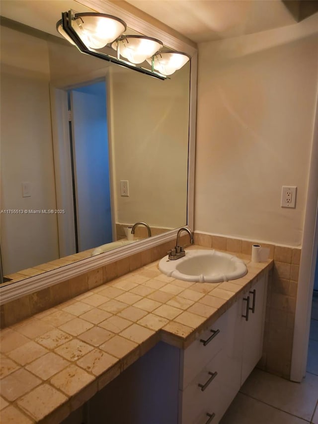 bathroom with tile patterned flooring, tile walls, and vanity