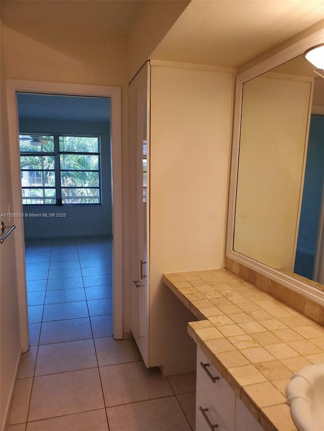 bathroom with tile patterned flooring and vanity