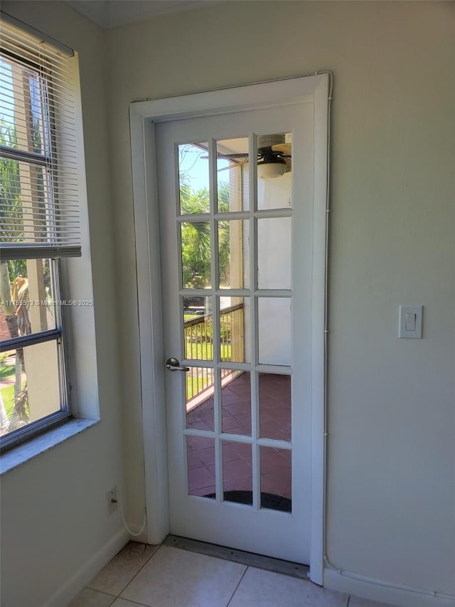 entryway with tile patterned flooring, french doors, and baseboards