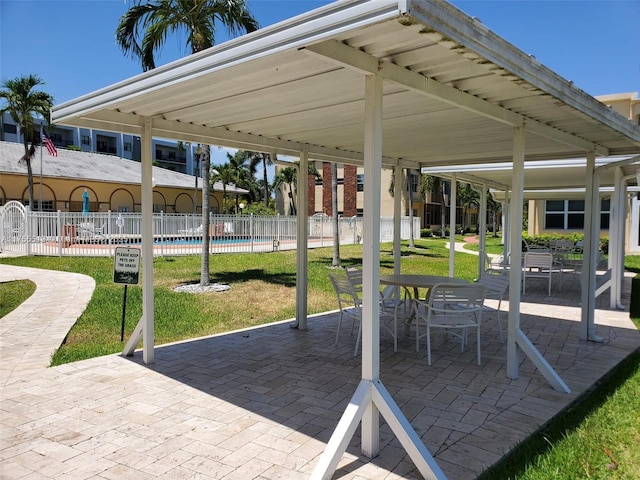 view of property's community featuring fence, a patio, and a yard