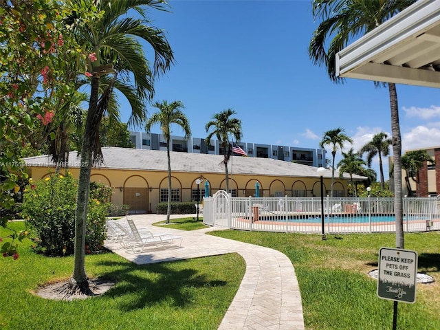 surrounding community with a yard, a patio, fence, and a pool