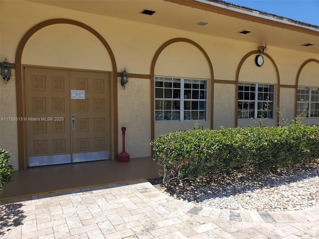 doorway to property with stucco siding