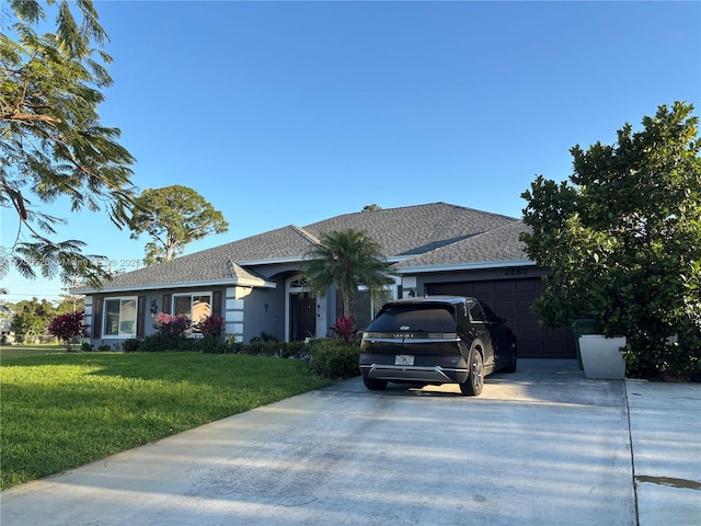 single story home featuring concrete driveway, an attached garage, and a front lawn