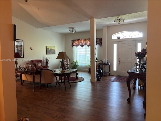 entrance foyer featuring wood finished floors, baseboards, and a textured ceiling