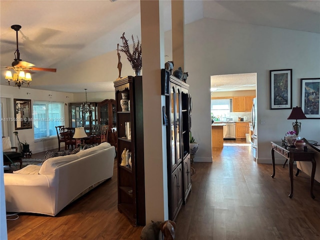 living room featuring a ceiling fan, vaulted ceiling, wood finished floors, and baseboards