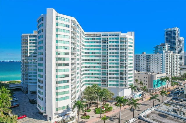 view of building exterior with a water view and a city view