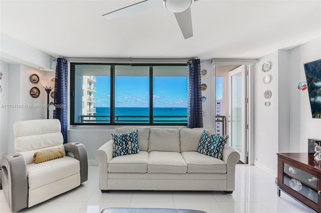 tiled living room with ceiling fan and baseboards