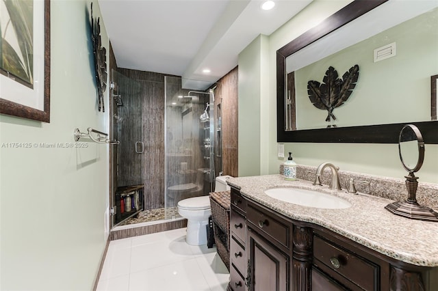 bathroom with toilet, tile patterned floors, vanity, a shower stall, and recessed lighting