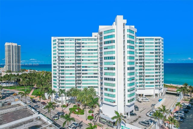 view of building exterior featuring a view of city and a water view