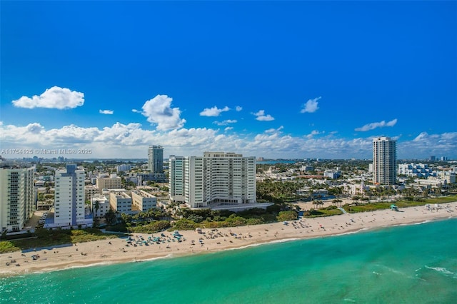 birds eye view of property featuring a water view, a city view, and a view of the beach