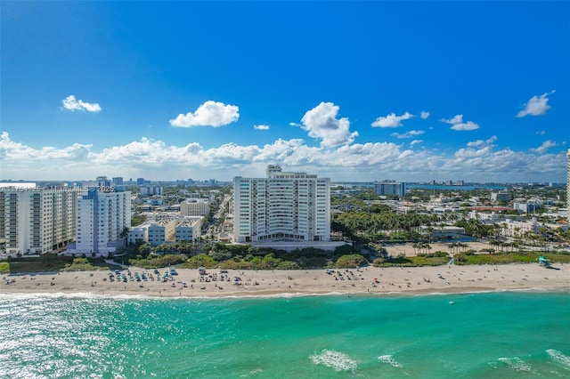 birds eye view of property featuring a view of the beach, a city view, and a water view