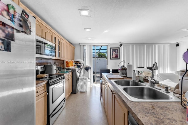 13190 SW 10th Terrace Dr Unit 13190, Miami, FL 33184 - kitchen featuring appliances with stainless steel finishes, light brown cabinets, a sink, glass insert cabinets, and a textured ceiling