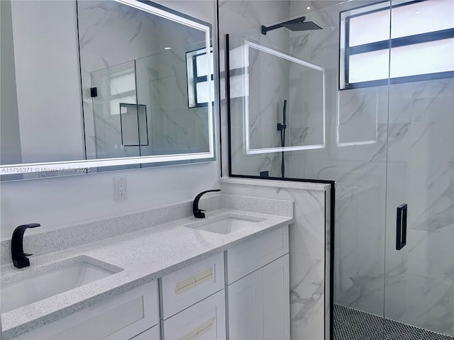 bathroom featuring double vanity, a marble finish shower, and a sink