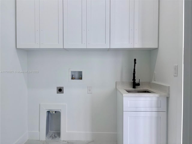 washroom featuring hookup for an electric dryer, washer hookup, a sink, baseboards, and cabinet space