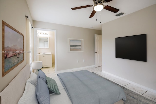 bedroom featuring light tile patterned floors, visible vents, ceiling fan, connected bathroom, and baseboards